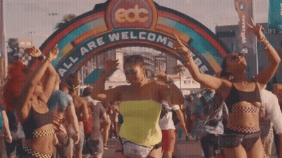 Women Dancing In Front Of EDC All Are Welcome Sign GIF