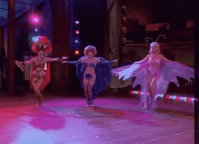 Women Dancing On Stage In Costume GIF
