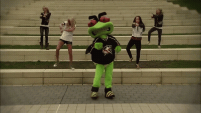 Women Dancing With Mascot In Blue Jersey GIF