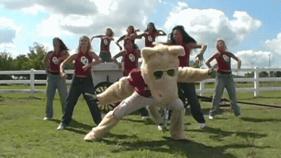 Women Dancing With Mascot Saying Oklahoma GIF