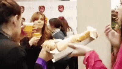 Women Drinking Beer And Eating Sandwiches GIF