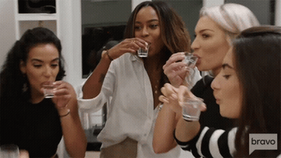 Women Drinking Shot Glasses With Bravo Logo GIF