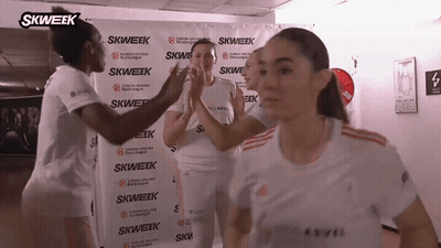 Women High-Fiving In Front Of Skweek Banner GIF