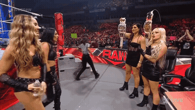Women Holding Championship Belt On Stage GIF
