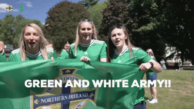 Women Holding Green And White Flag Saying Green And White Army GIF
