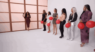 Women In A Row Holding Red Balloons GIF