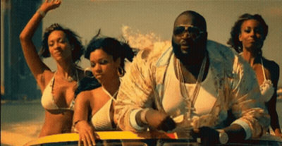 Women In Bikinis Riding Boat With Man In White Shirt GIF