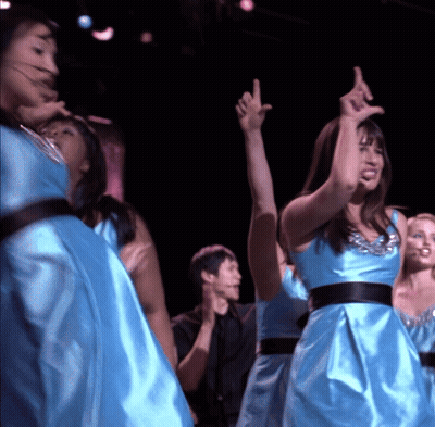 Women In Blue Satin Dresses Dancing On Stage GIF