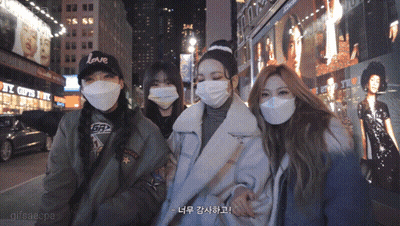 Women In Face Masks Posing In Front Of Love Building GIF