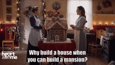 Women In Front Of Gingerbread House GIF