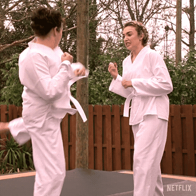 Women In Karate Uniforms Kicking GIF