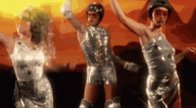 Women In Silver Dresses Dancing In Front Of Sunset GIF