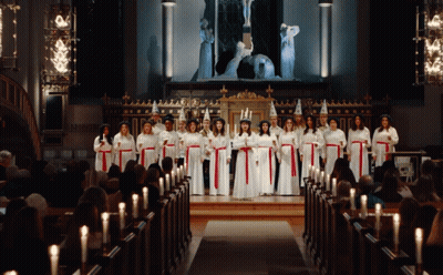 Women In White And Red Holding Candles In Church GIF