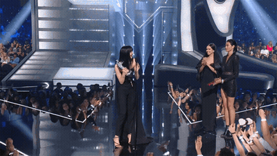 Women On Stage In Front Of Crowd GIF