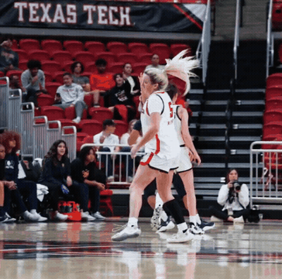 Women Playing Basketball In Front Of A Banner That Says " Texas Tech " GIF