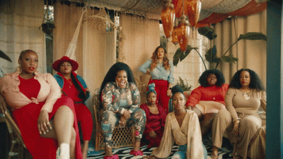 Women Posing For Picture, One In Red Hat GIF