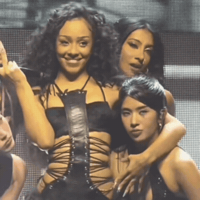 Women Posing, One In Black Lace Top GIF