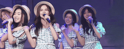 Women Singing Into Microphones Wearing Straw Hats GIF