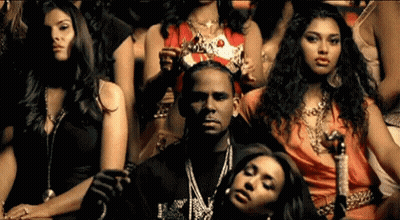 Women Sitting Around Man In Crown GIF