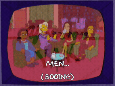 Women Sitting Around Table Booing Men GIF