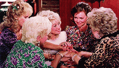 Women Sitting Around Table Hands On Wrists GIF