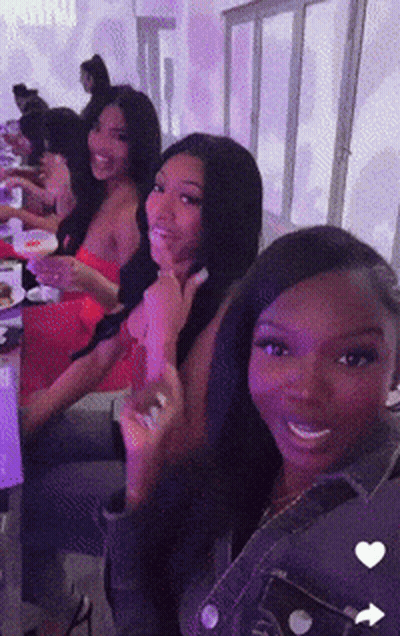 Women Sitting At Table With Purple Lights GIF