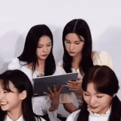 Women Sitting At Table With Tablet GIF