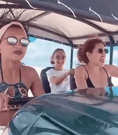 Women Sitting In Golf Cart On Beach GIF