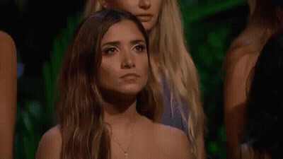 Women Sitting In Row, One Looking At Camera GIF