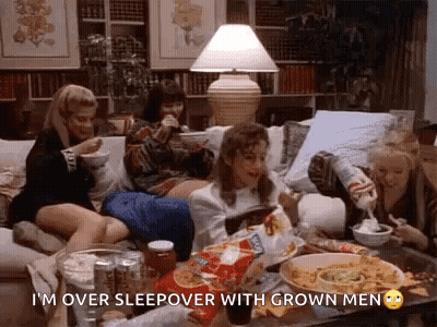 Women Sitting On Couch Eating Chips And Drinking Soda GIF