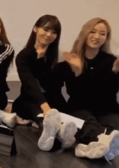 Women Sitting On Couch With Feet In Shoes GIF