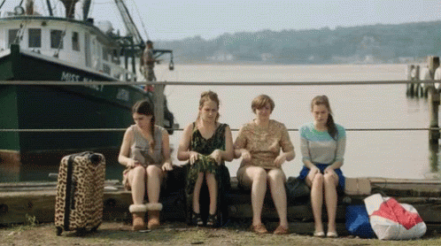 Women Sitting On Dock In Front Of Miss Valley Boat GIF