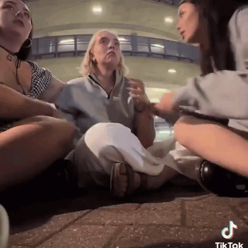 Women Sitting On Ground With TikTok GIF