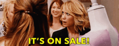 Women Standing Around Mannequin Saying It's On Sale GIF