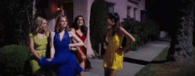 Women Standing On Sidewalk In Front Of House GIF