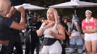 Women Standing Under Umbrellas With NM Shirt GIF