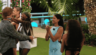 Women Surrounding Man In Blue Dress GIF