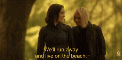 Women Walking In Woods Discussing Living On Beach GIF