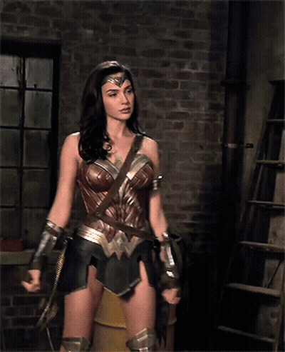 Wonder Woman Standing In Front Of Brick Wall GIF