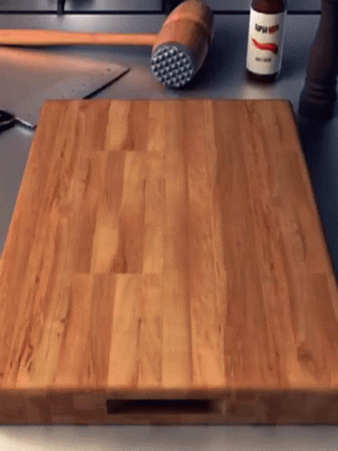 Wooden Cutting Board With Super Hot Sauce Bottle GIF