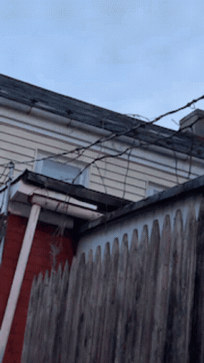 Wooden Fence In Front Of House With Roof GIF