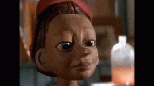 Wooden Puppet Face With Red Hat GIF