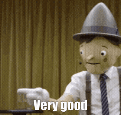 Wooden Puppet In Suit Pointing 'Very Good GIF