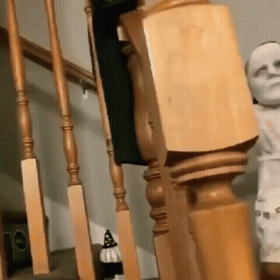 Wooden Railing Next To Statue Of Man GIF