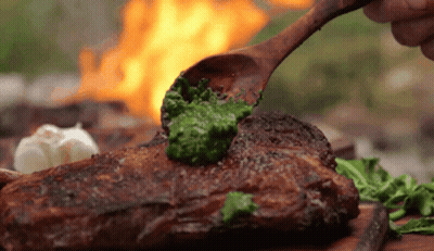 Wooden Spoon Spreading Pesto On Steak GIF