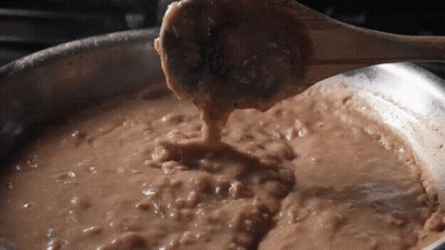 Wooden Spoon Stirring Brown Liquid GIF