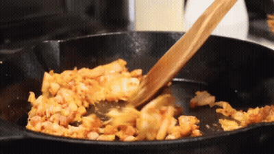Wooden Spoon Stirring Food In Frying Pan GIF