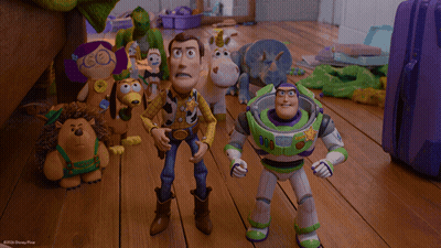 Woody And Buzz Lightyear Are Standing Next To Each Other In A Scene From Toy Story GIF