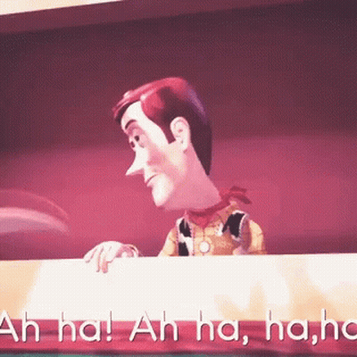 Woody From Toy Story Is Laughing While Looking Over A Table GIF