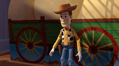 Woody From Toy Story Is Standing In Front Of A Green Wagon GIF